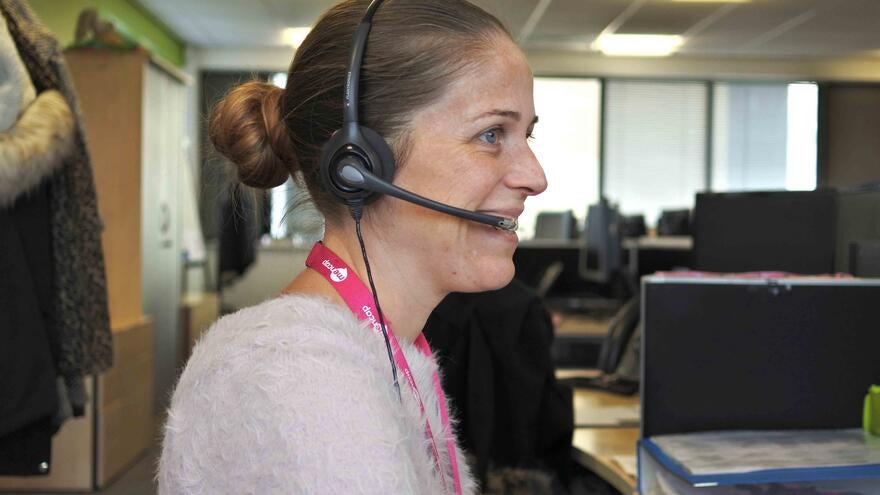 A picture of someone working in the Mencap Helpline team